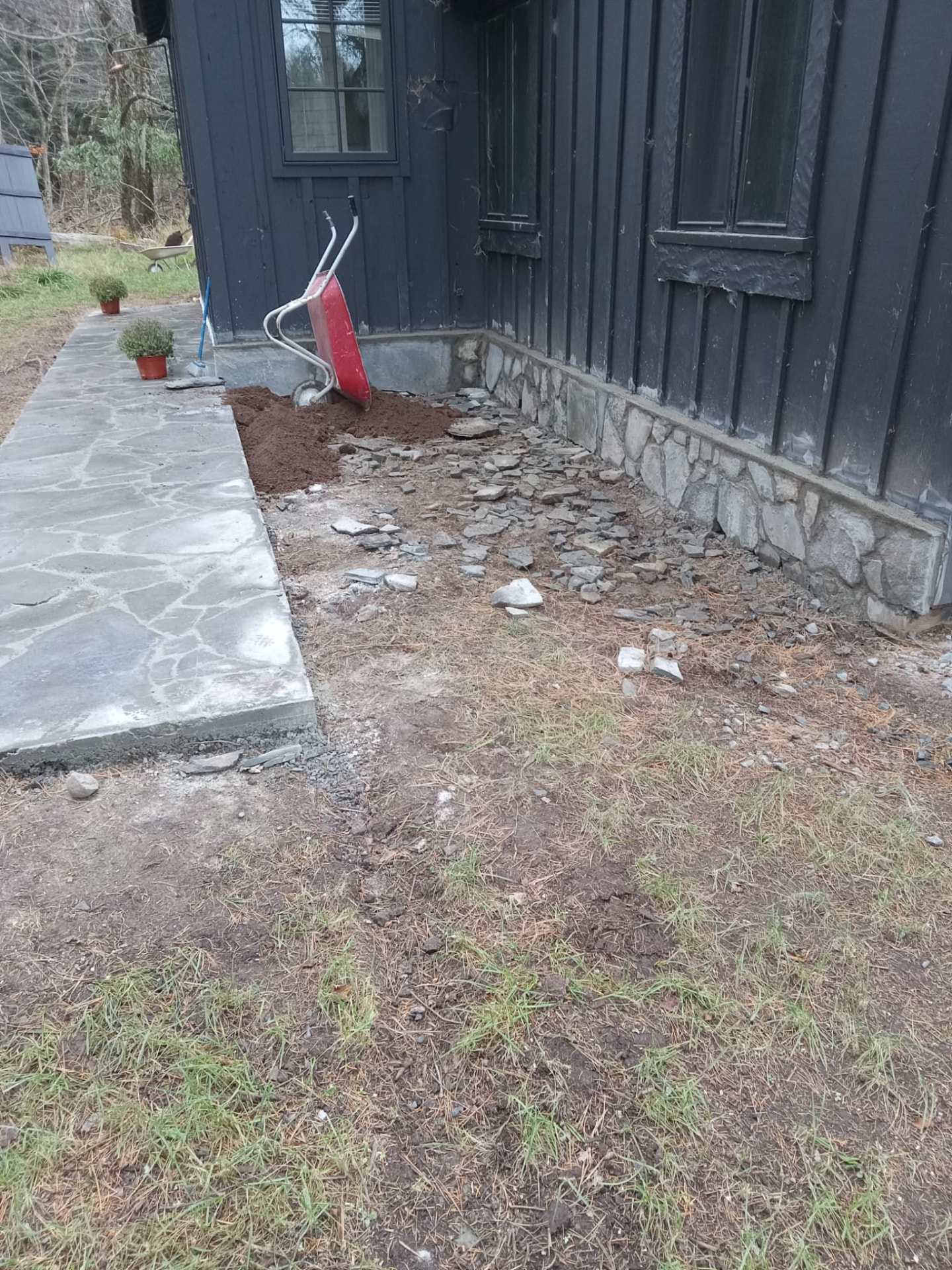 Mason installing stacked stone veneer on an exterior wall