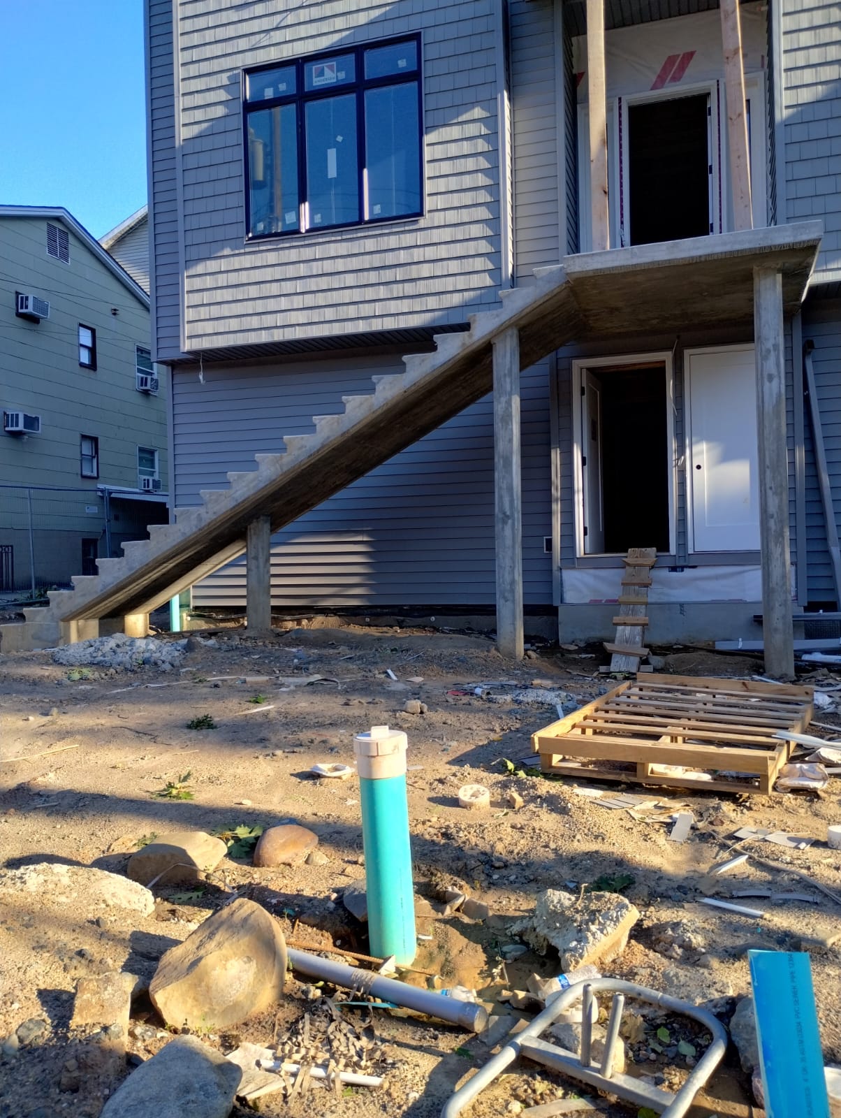 Masonry stairs under construction on the exterior of a multi-story residential building